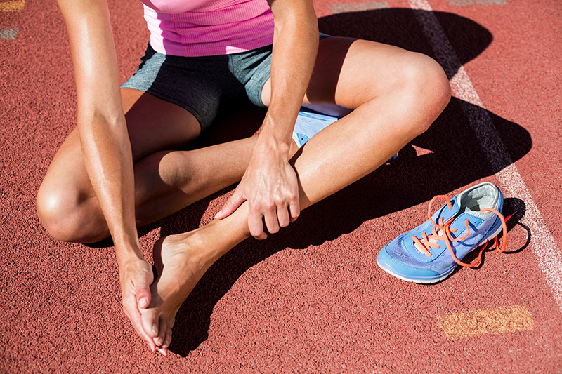Athlete experiencing foot and ankle pain from a sports injury requiring diagnosis and treatment.