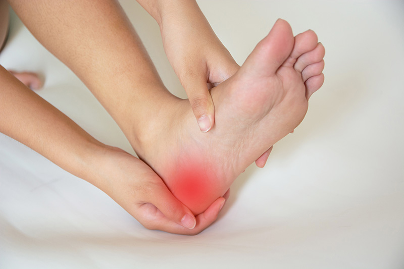 Close-up of heel pain affecting the bottom of the foot and causing discomfort during movement.